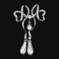 Pearl and diamond brooch, <b>1860</b>-1880Designed as a stylised loose ribbon, set with circular- and rose-cut diamonds, suspending thr