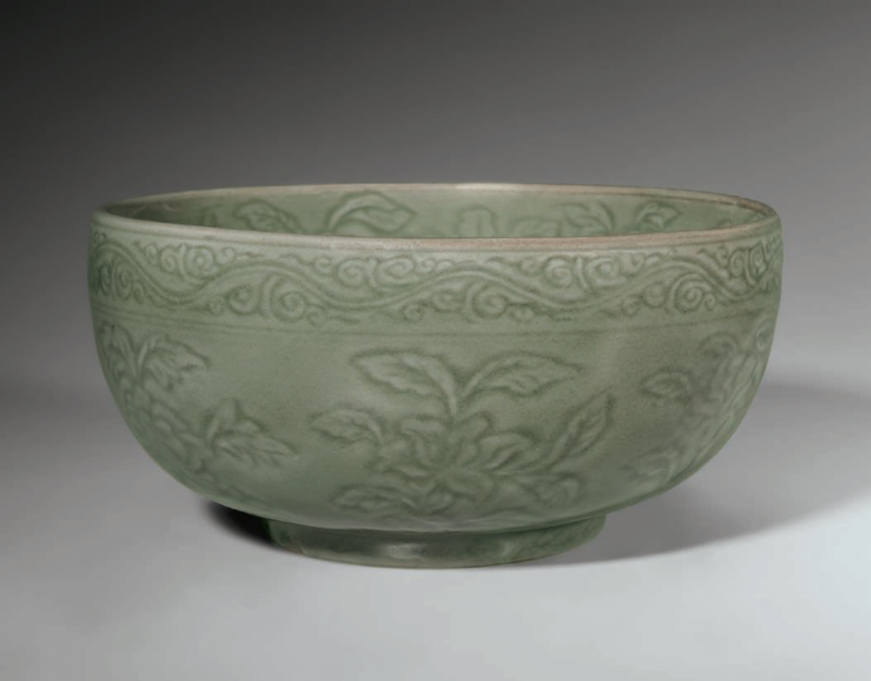 A rare carved Longquan celadon deep bowl, Ming dynasty, early 15th century