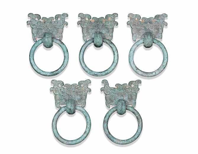 A set of five archaic bronze 'Taotie mask' ring handles, pushou, Eastern Zhou Dynasty (770-256 BCE)