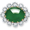 A magnificent oval jadeite cabochon and diamond pendant-brooch, mounted by <b>Carvin</b> <b>French</b>