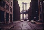 manhattan-bridge-tower-in-brooklyn-framed-through-nearby-buildings