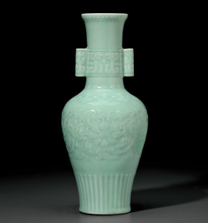 A rare celadon-glazed relief-decorated baluster vase, Qianlong six-character seal mark in underglaze blue and of the period (1736-1795)