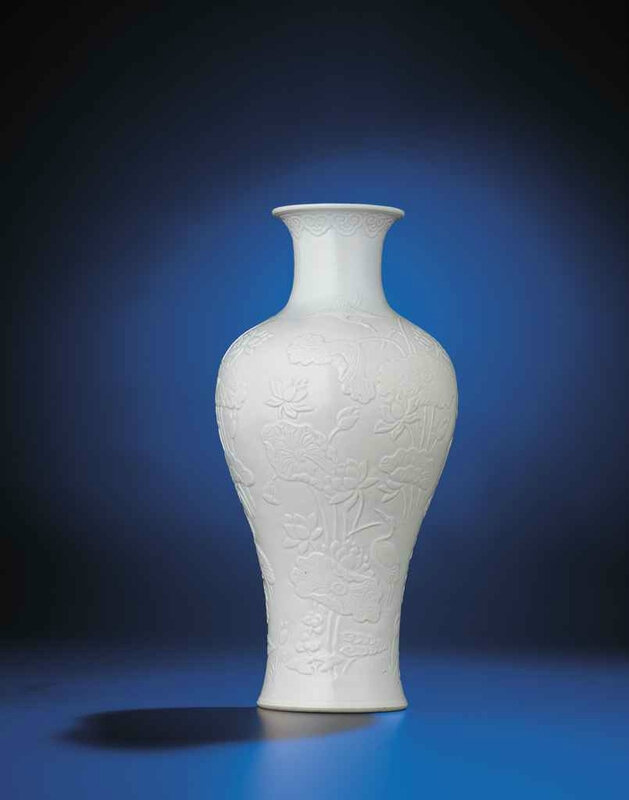 A rare relief-decorated white-glazed baluster vase, Qianlong incised six-character seal mark and of the period (1736-1795)
