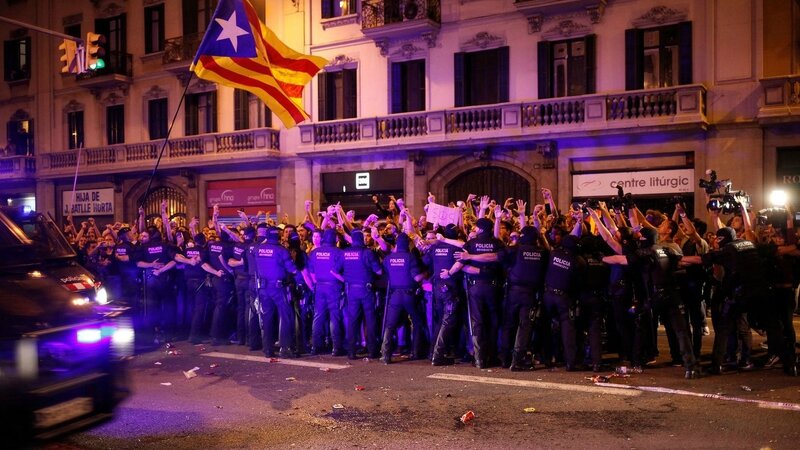 demonstrators-are-stopped-by-catalan-mossos-d-esquadra-officers-while-spanish-national-police-officers-leave-their-headquarters-in-a-van-in-bar