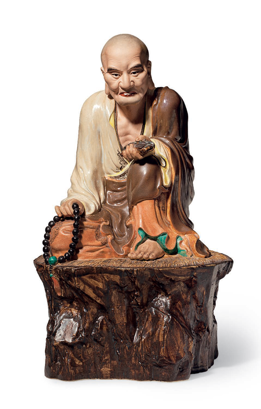 A polychrome-enameled and biscuit figure of a seated luohan, impressed seal of Zeng Longsheng, Republic period