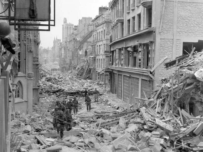 650682-handout-photo-of-canadian-troops-patrolling-along-the-destroyed-rue-saint-pierre-after-german-forces