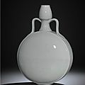 A fine and very rare Ming tianbai-glazed anhua-decorated moonflask, <b>bianping</b>, Yongle period (1403-1424)