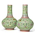 A rare pair of <b>green</b>-<b>ground</b> famille-rose bottle vases, Qianlong seal marks and period