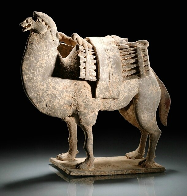 A grey pottery figure of a loaded camel, Northern Wei dynasty, 6th century