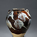A phosphatic glaze-<b>splashed</b> brownglazed jar with handles, Tang dynasty (618-907)