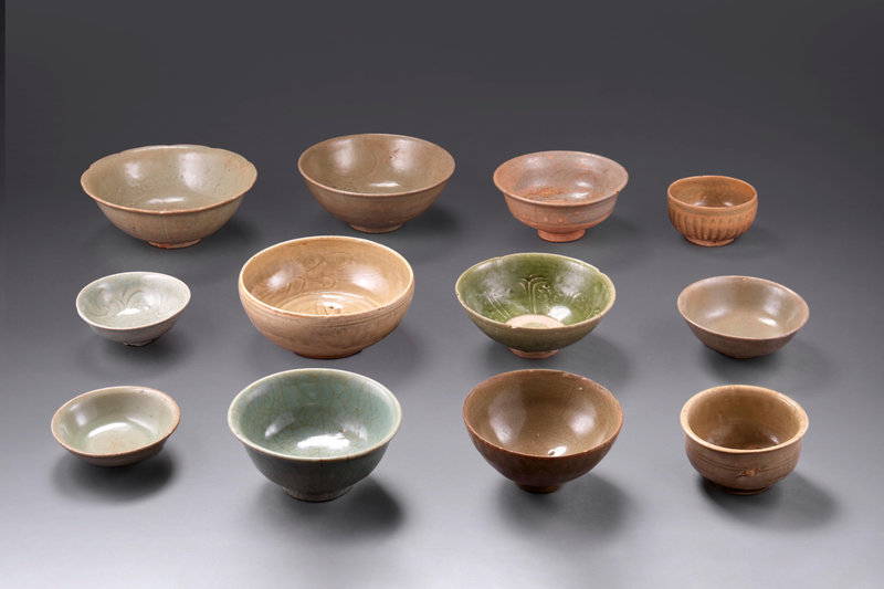 A group of twelve green-glazed bowls, China and Vietnam, 13th-15th century