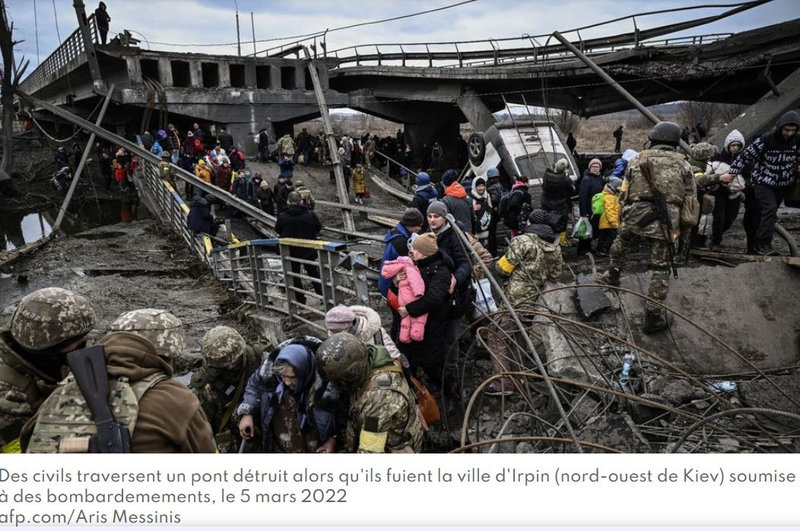 O passage de civils après le bombardement d'un pont près de Kiev