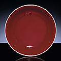 An extremely rare early Ming copper-red glazed shallow dish. <b>Xuande</b> <b>six</b>-<b>character</b> <b>mark</b> <b>within</b> <b>double</b>-<b>circles</b> <b>and</b> <b>of</b> <b>the</b> period 