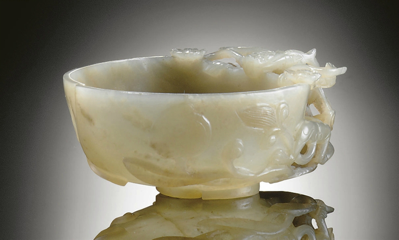 A carved pale green jade peach-form libation cup, Ming dynasty, 17th century