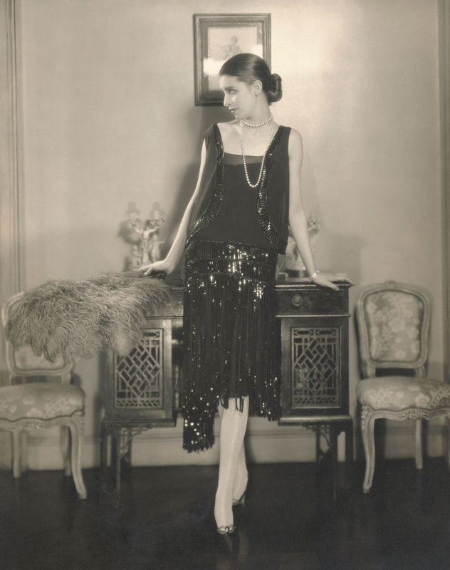 Marion Morehouse, wearing a black crepe romain bolero dress with fringed and paillette embroidered skirt by Chanel