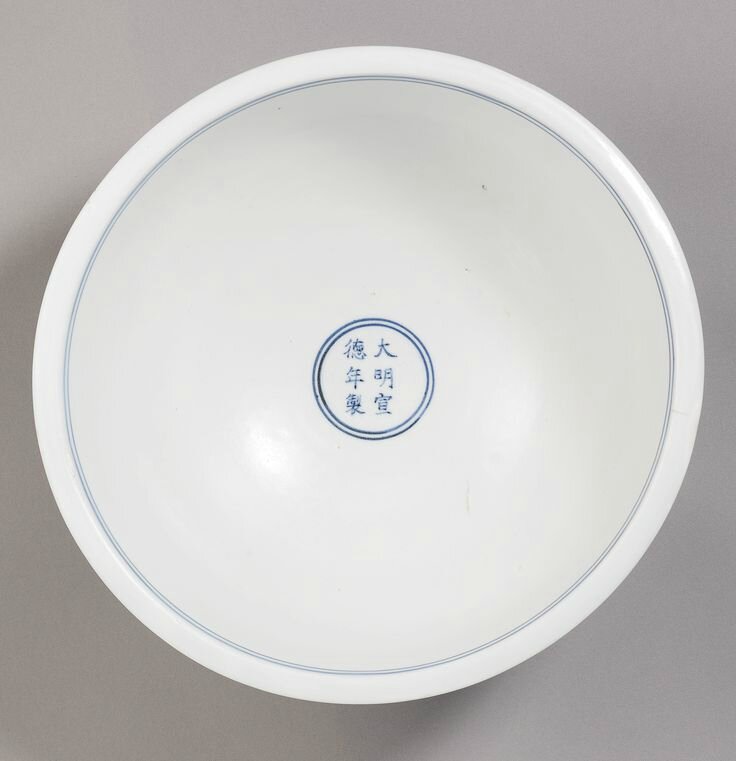 White porcelain bowl with dragon design in red glaze, Ming