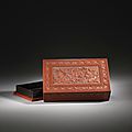 A large Imperial <b>cinnabar</b> lacquer 'Budhhist lion' rectangular box and cover, Qianlong six-character mark and of the period